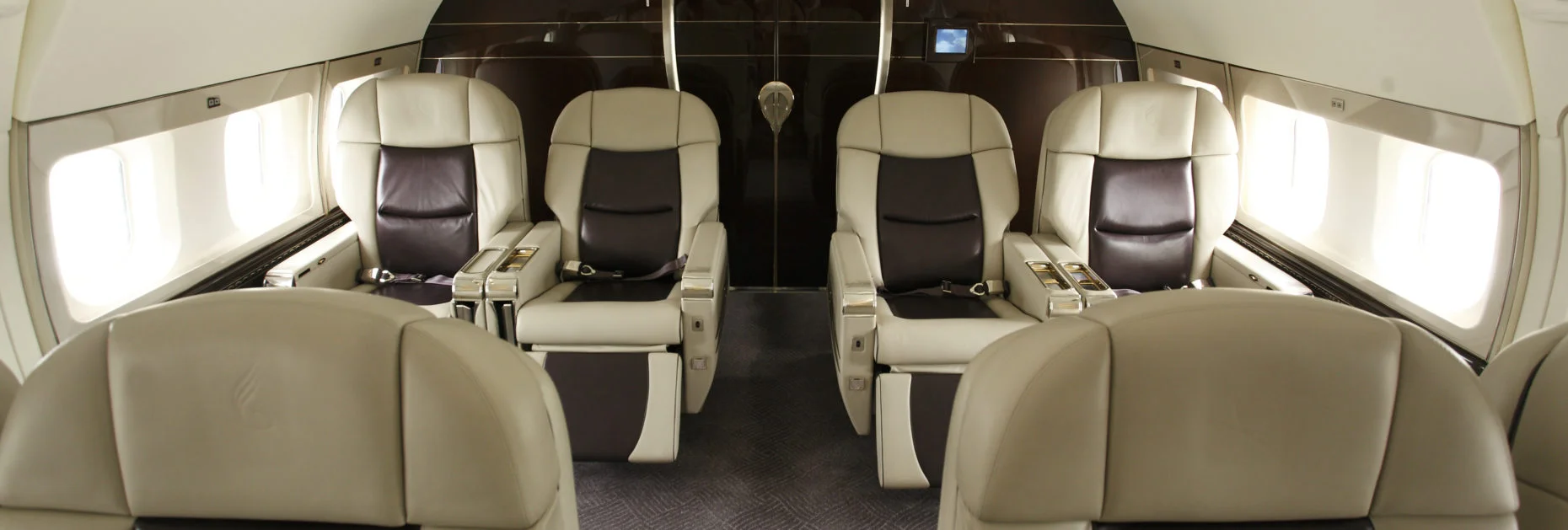 Photo focusing on the stitching and leather quality of first class seats.