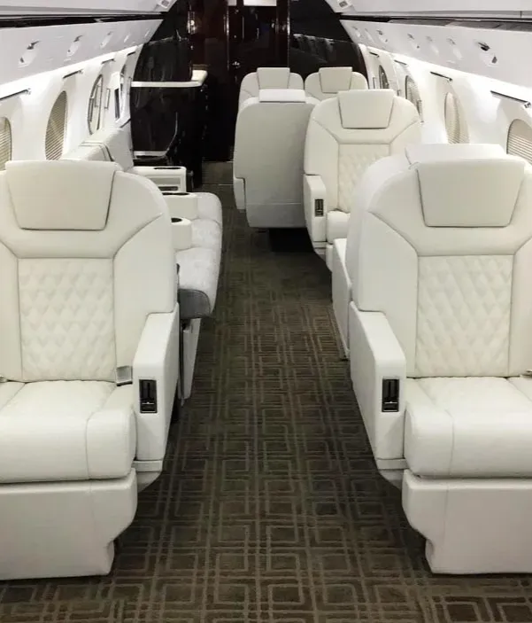 Wide shot of a luxury aircraft interior with plush seats and elegant decor.