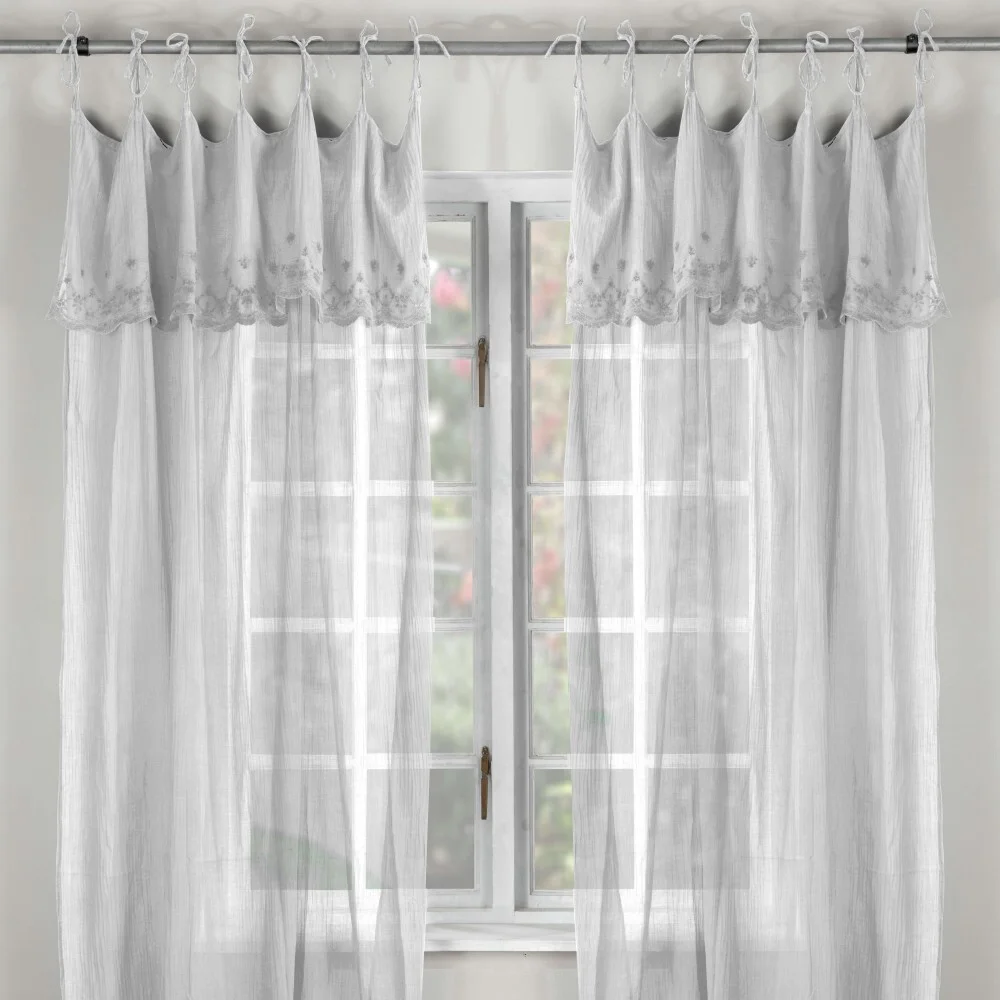 Layered curtains featuring sheer and patterned fabric